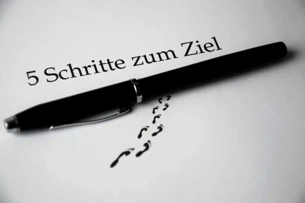 A black pen on a paper with text and footprint visual elements for a conceptual theme.